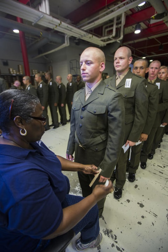 Marine Corps Recruit Jared P. McCrobie Jr., has his blouse marked by a tailor during the company’s uniform clothing issue July 15, 2015, on Parris Island, S.C. MCRD Parris Island was one of three recruit training centers to receive the DLA distribution standard system, an audit ready inventory tracking software that provides better accountability of DLA assets at RTCs.