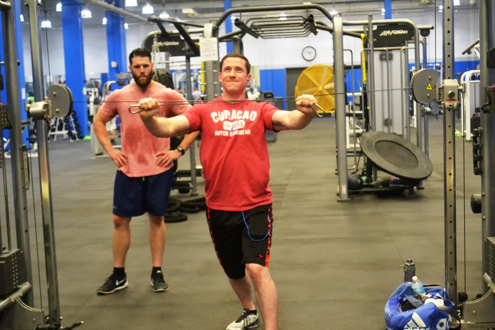 Matthew Eckenrode, left, looks on as Ryan Guarnere utilizes one on the machines in at the NSA-Philadelphia gym June 23. Both began working out together just a few weeks ago; however, Guarnere says with Eckenrode’s assistance and motivation, he is already seeing results. 