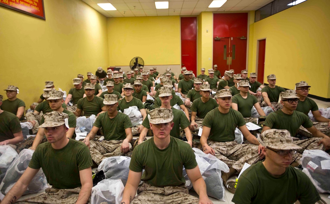 U.S. Marine Corps recruits await orders after changing into their first set of uniforms upon arrival at Marine Corps Recruit Depot San Diego March 14. MCRD San Diego was one of three recruit training centers to receive the DLA distribution standard system, an audit ready inventory tracking software that provides better accountability of DLA assets at RTCs. 