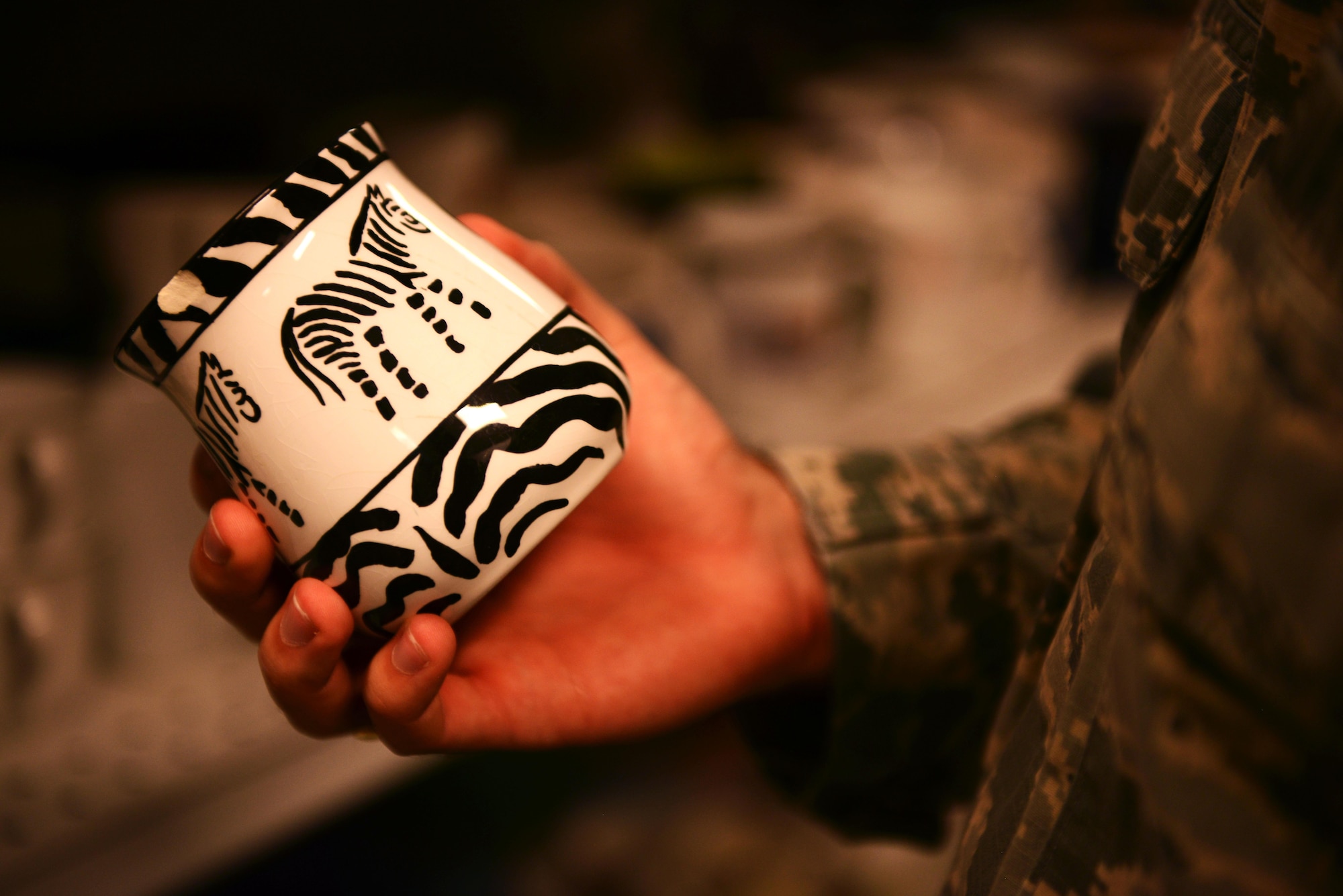A customer picks up a cup from a shelf at the Airman’s Attic at Ramstein Air Base, Germany, June 24, 2016. The Airman’s Attic offers secondhand dishes, electronics, clothing and household goods free of charge to active duty military members E-5 and below. (U.S. Air Force Photo/ Airman 1st Class Joshua Magbanua)