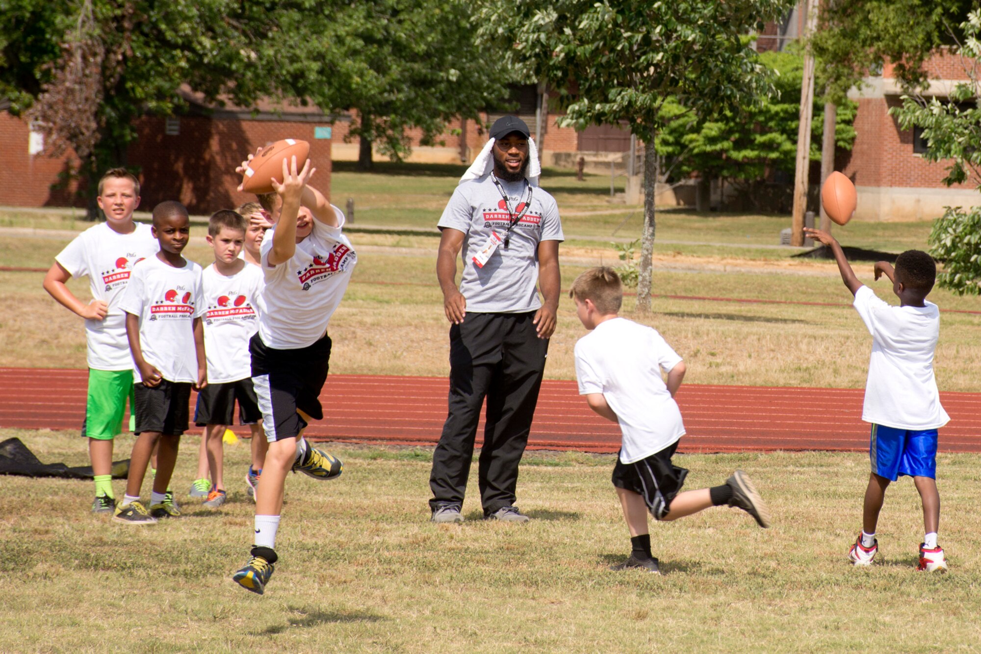 Campers show of their individual skills before opening ceremonies for the Darren McFadden Football ProCamp at Little Rock Air Force Base, Ark., June 23, 2016. McFadden, a running back for the Dallas Cowboys of the National Football League, hosted the two-day event, which was free to military children in grades 1-8. The ProCamp offered instruction on fundamental skills and the finer points of football. (U.S. Air Force photo by Master Sgt. Jeff Walston/Released)
