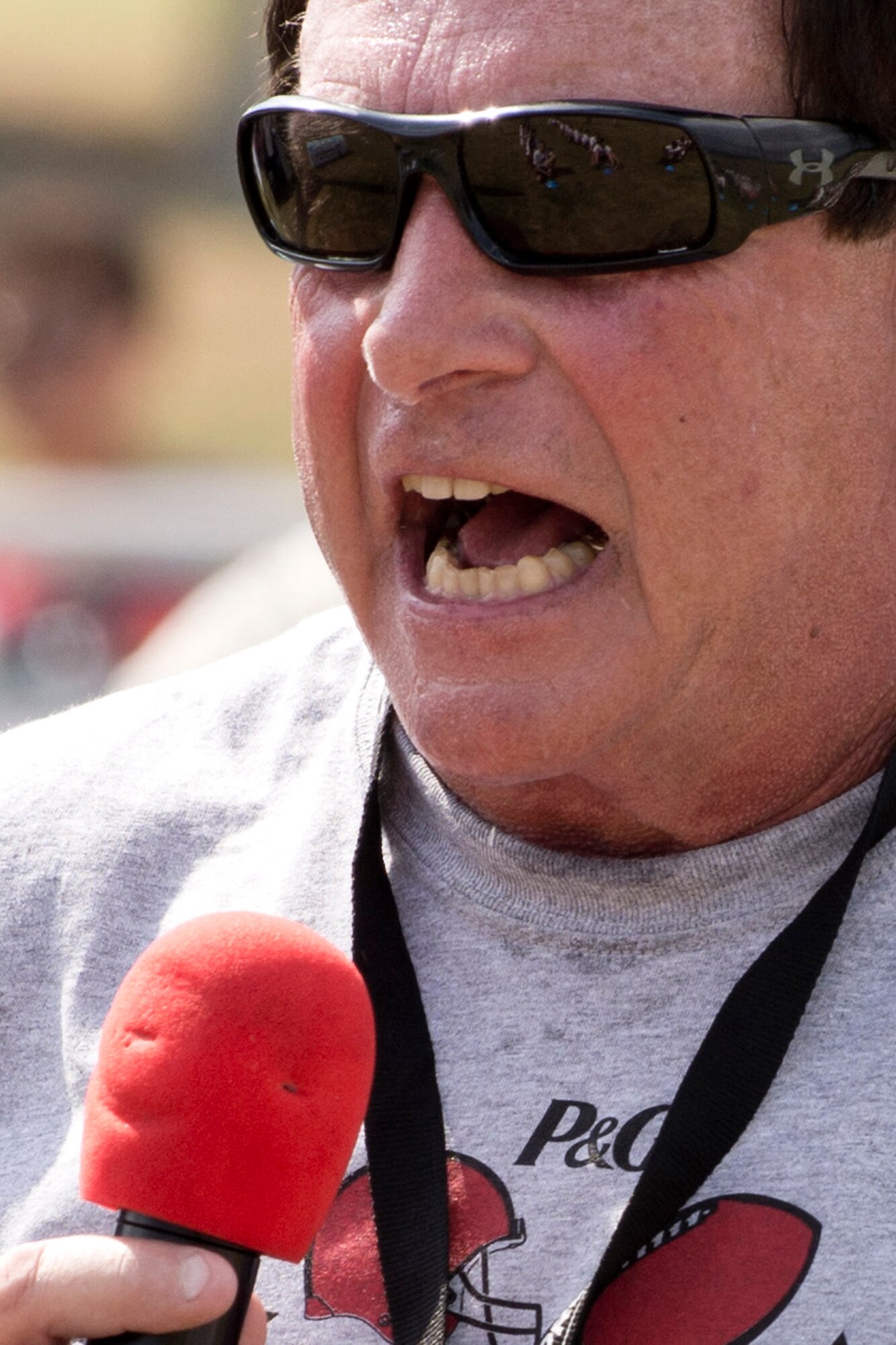 Coach Conley inspires the crowd during opening ceremonies for the Darren McFadden Football ProCamp at Little Rock Air Force Base, Ark., June 23, 2016. McFadden, a former Arkansas Razorback, and now running back for the Dallas Cowboys of the National Football League, hosted the ProCamp. The two-day event, which was free to military children in grades 1-8, offered instruction on fundamental skills and the finer points of football. (U.S. Air Force photo by Master Sgt. Jeff Walston/Released)
