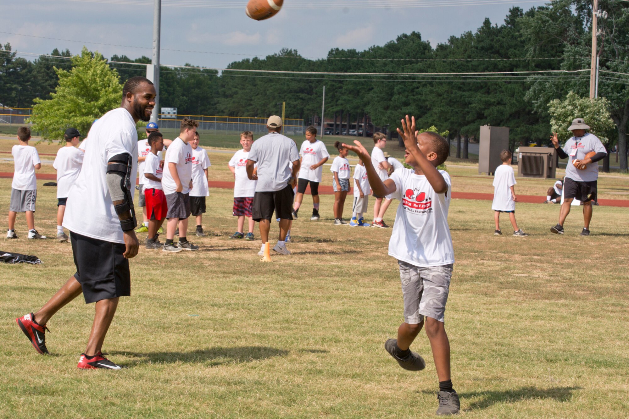 A camper attempts to catch a pass during the Darren McFadden Football ProCamp at Little Rock Air Force Base, Ark., June 23, 2016. McFadden, a running back for the Dallas Cowboys of the National Football League, hosted the two-day event, which offered instruction on fundamental skills and the finer points of football to approximately 150 military children. (U.S. Air Force photo by Master Sgt. Jeff Walston/Released)