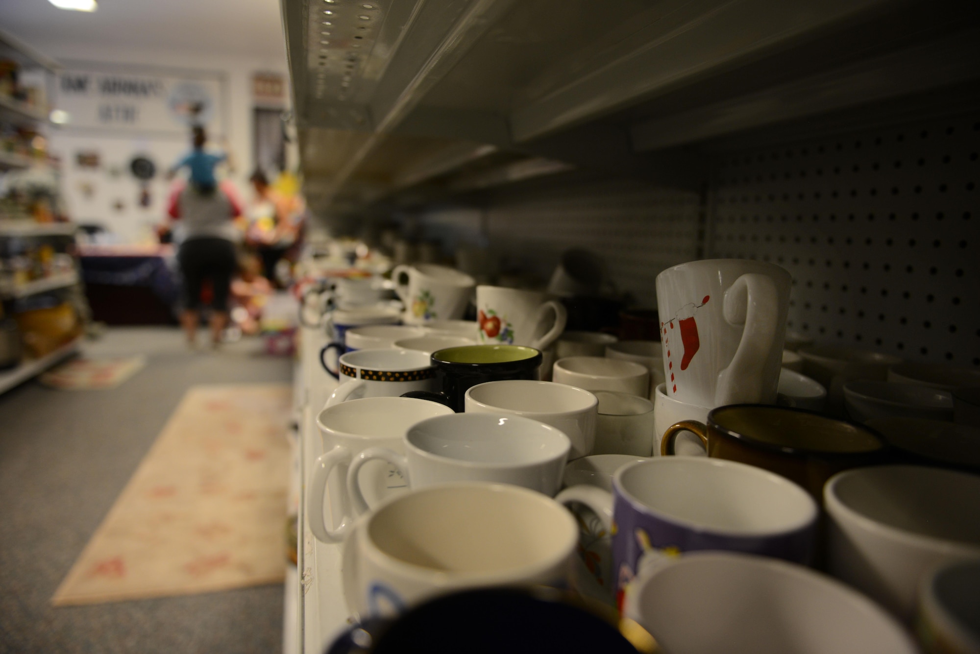 Cups line the shelves of the Airman’s Attic at Ramstein Air Base, Germany, June 24, 2016. The Airman’s Attic serves military members E-5 and below by providing them with free household goods. (U.S. Air Force Photo/ Airman 1st Class Joshua Magbanua)