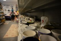Cups line the shelves of the Airman’s Attic at Ramstein Air Base, Germany, June 24, 2016. The Airman’s Attic serves military members E-5 and below by providing them with free household goods. (U.S. Air Force Photo/ Airman 1st Class Joshua Magbanua)