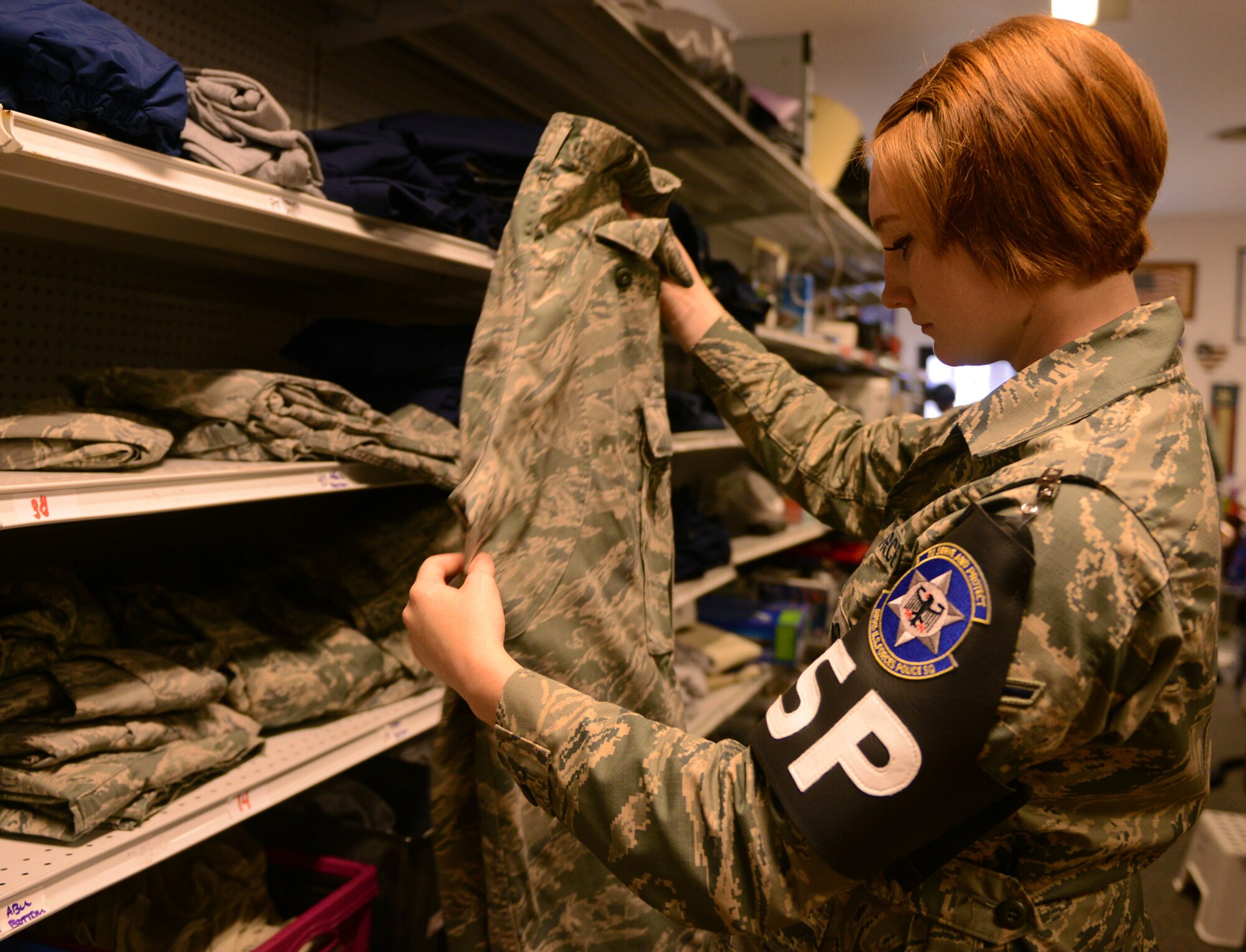 Airman Claire Hilborn, 569th U.S. Forces Police Squadron security forces member, looks at a pair of Airman Battle Uniform trousers at the Airman’s Attic at Ramstein Air Base, Germany, June 24, 2016. The Airman’s Attic offers free uniforms along with household goods to active-duty military members E-5 and below. (U.S. Air Force Photo/ Airman 1st Class Joshua Magbanua)