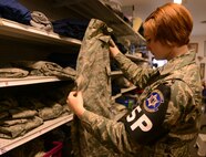 Airman Claire Hilborn, 569th U.S. Forces Police Squadron security forces member, looks at a pair of Airman Battle Uniform trousers at the Airman’s Attic at Ramstein Air Base, Germany, June 24, 2016. The Airman’s Attic offers free uniforms along with household goods to active-duty military members E-5 and below. (U.S. Air Force Photo/ Airman 1st Class Joshua Magbanua)