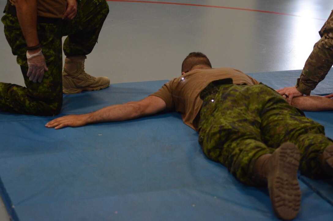 A Canadian Military Police (MP) Soldier with the 1st MP Regiment from Edmonton, Alberta, Canada, is successfully hit by both barbs from an X26E Taser and experiences neuromuscular incapacitation at Fort McCoy, Wisc., June 22, 2016. Guardian Justice is a military exercise which focuses on training both American and Canadian military police forces in detainee operations and non-lethal weapons applications. (U.S. Army photo by Spc. Adam Parent)