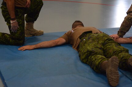 A Canadian Military Police (MP) Soldier with the 1st MP Regiment from Edmonton, Alberta, Canada, is successfully hit by both barbs from an X26E Taser and experiences neuromuscular incapacitation at Fort McCoy, Wisc., June 22, 2016. Guardian Justice is a military exercise which focuses on training both American and Canadian military police forces in detainee operations and non-lethal weapons applications. (U.S. Army photo by Spc. Adam Parent)