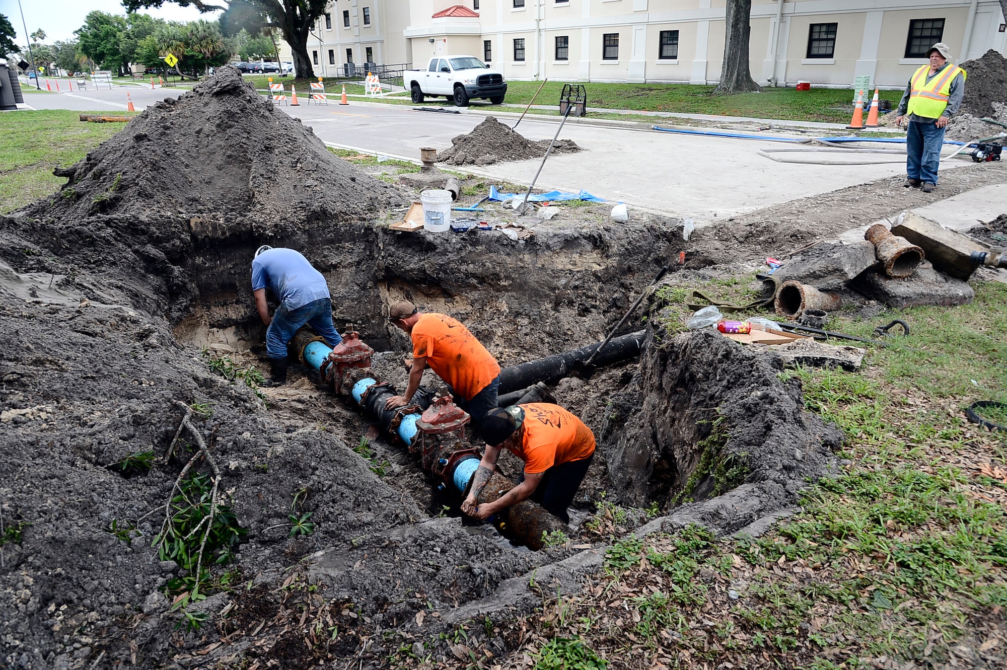 Contractors fix a broken water main by replacing an old pipe with a new one at MacDill Air Force Base, Fla. June 10, 2016. They replaced the pipe with a new section of eight-inch ductile iron piping across the entire road and other needed piping connections were installed to correct the damage. 