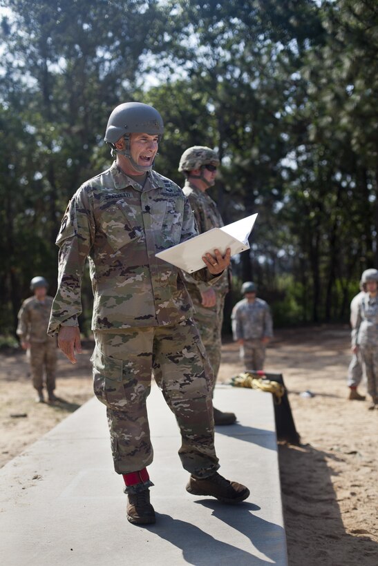 Lt. Col. Dan Grasseti, U.S. Army Civil Affairs & Psychological Operations Command (Airborne), gives a brief to paratroopers prior to an airborne operation over St. Mere Eglise drop zone near Fort Bragg, N.C. on June 25, 2016. USACAPOC (A), an Army Reserve unit, conducts airborne operations in order to maintain currency and proficiency. USACAPOC(A) supports the Army and Joint Force with strategic, operational, and tactical civil affairs, military information support, and information operations capabilities across the range of military operations. (U.S. Army photo by Staff Sgt. Felix Fimbres)