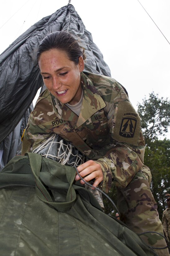 Spc. Kristen Root, 982nd Combat Camera company packs a parachute after it’s been shaken following succesfull jump onto St. Mere Eglise drop zone on June 25. 2016. The 982nd, an Army Reserve unit, provides our military leaders and government officials first-hand, still and video imagery (both released and classified), of our forces in the field. They are the "Eyes and Ears" of the decision makers.  (U.S. Army photo by Staff Sgt. Felix Fimbres)