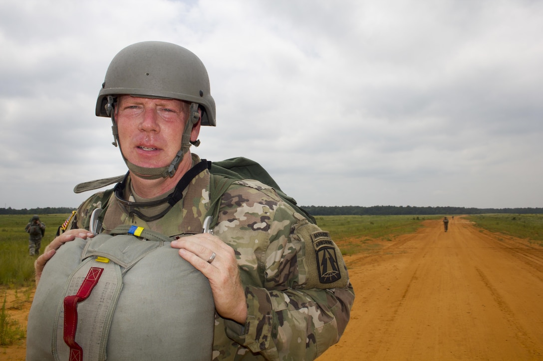 Maj. Christopher Murphy, Commander of the 982nd Combat Camera Company, walks off St. Mere Eglise drop zone after a successful jump at Fort Bragg, N.C. on June 25, 2016. The 982nd, an Army Reserve unit, provides our military leaders and government officials first-hand, still and video imagery (both released and classified), of our forces in the field. They are the "Eyes and Ears" of the decision makers.  (U.S. Army photo by Staff Sgt. Felix Fimbres)