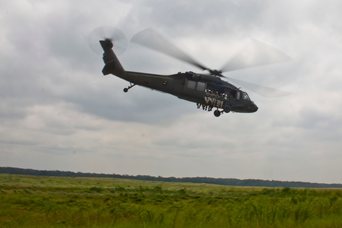 U.S. Army Reserve Paratroopers participate in an airborne operation hosted by the U.S. Army Civil Affairs & Psychological Operations Command (Airborne) at St. Mere Elise Drop Zone near Fort Bragg, N.C. on June 25, 2016.  USACAPOC (A), an Army Reserve unit, conducts airborne operations in order to maintain currency and proficiency. USACAPOC(A) supports the Army and Joint Force with strategic, operational, and tactical civil affairs, military information support, and information operations capabilities across the range of military operations. (U.S. Army photo by Staff Sgt. Felix R. Fimbres)