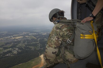 Spc. Kristen Root, 982nd Combat Camera Company, awaits the command to jump from Sgt. Christopher Emmons, U.S. Army Civil Affairs & Psychological Operations Command (Airborne), shouts commands inside a UH-60 Blackhawk during an airborne operation over St. Mere Eglise drop zone near Fort Bragg, N.C. on June 25, 2016. The USACAPOC(A), an Army Reserve unit, conducts airborne operations in order to maintain currency and proficiency. USACAPOC(A) supports the Army and Joint Force with strategic, operational, and tactical civil affairs, military information support, and information operations capabilities across the range of military operations. (U.S. Army photo by Staff Sgt. Felix Fimbres)