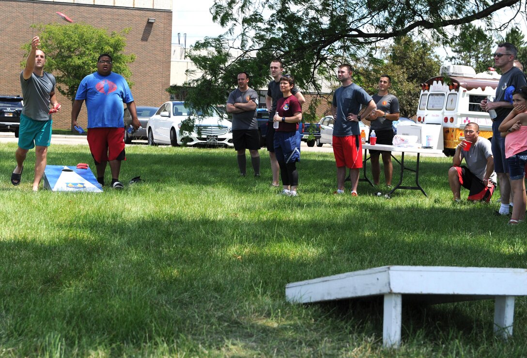 Members of the National Air and Space Intelligence Center compete in a cornhole game during the Center's annual Sports Fest on Wright-Patterson Air Force Base, Ohio, June 17, 2016. Sports Fest is a multi-sports elimination competition between the Center’s groups. (U.S. Air Force photo/Senior Airman William K. Veyon)