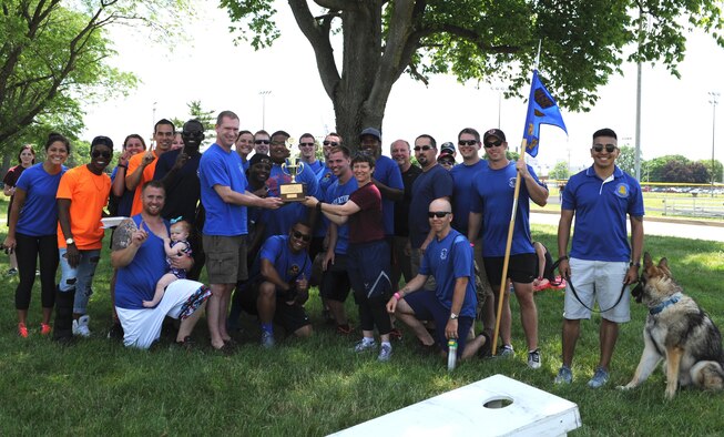 Members of the Space, Missiles, and Forces Intelligence Group pose of a victory photo with Col. Trisha Sexton, National Air and Space Intelligence Center vice commander, after winning the Sports Fest trophy at Wright-Patterson Air Force Base, Ohio, June 17, 2016. Sports Fest is a multi-sports elimination competition between the Center’s groups. (U.S. Air Force photo/Senior Airman William K. Veyon)