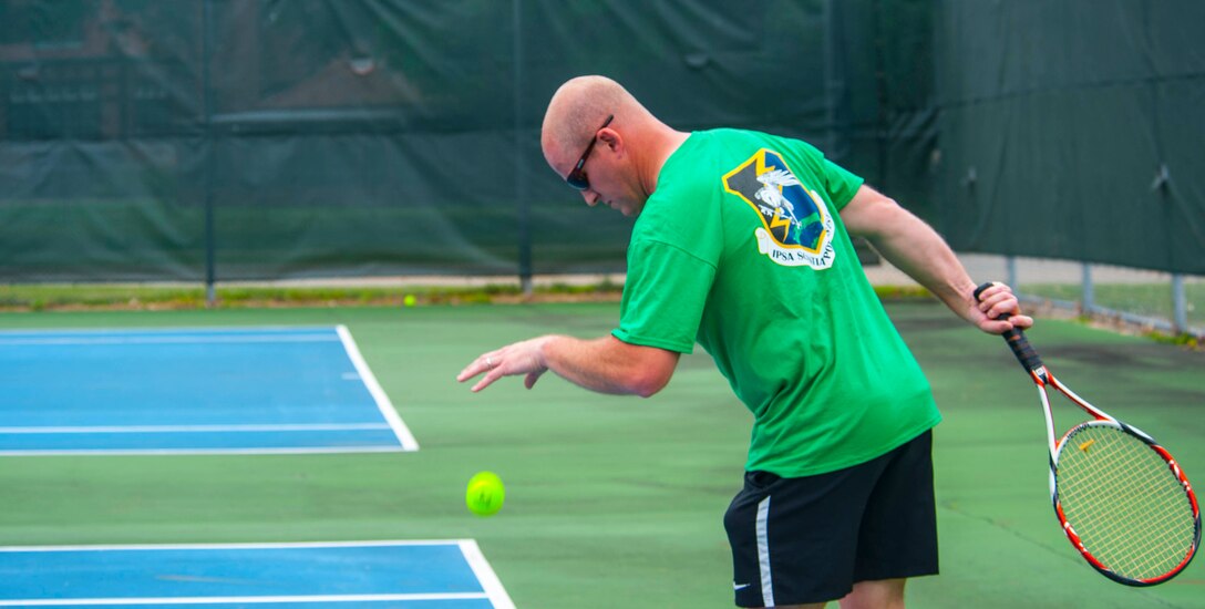 A member of the National Air and Space Intelligence Center prepares to serve during a tennis match that was part of the Center's annual Sports Fest at the Jarvis Gym track on Wright-Patterson Air Force Base, Ohio, June 17, 2016. (U.S. Air Force photo/Tech. Sgt. Eunique P. Thomas)