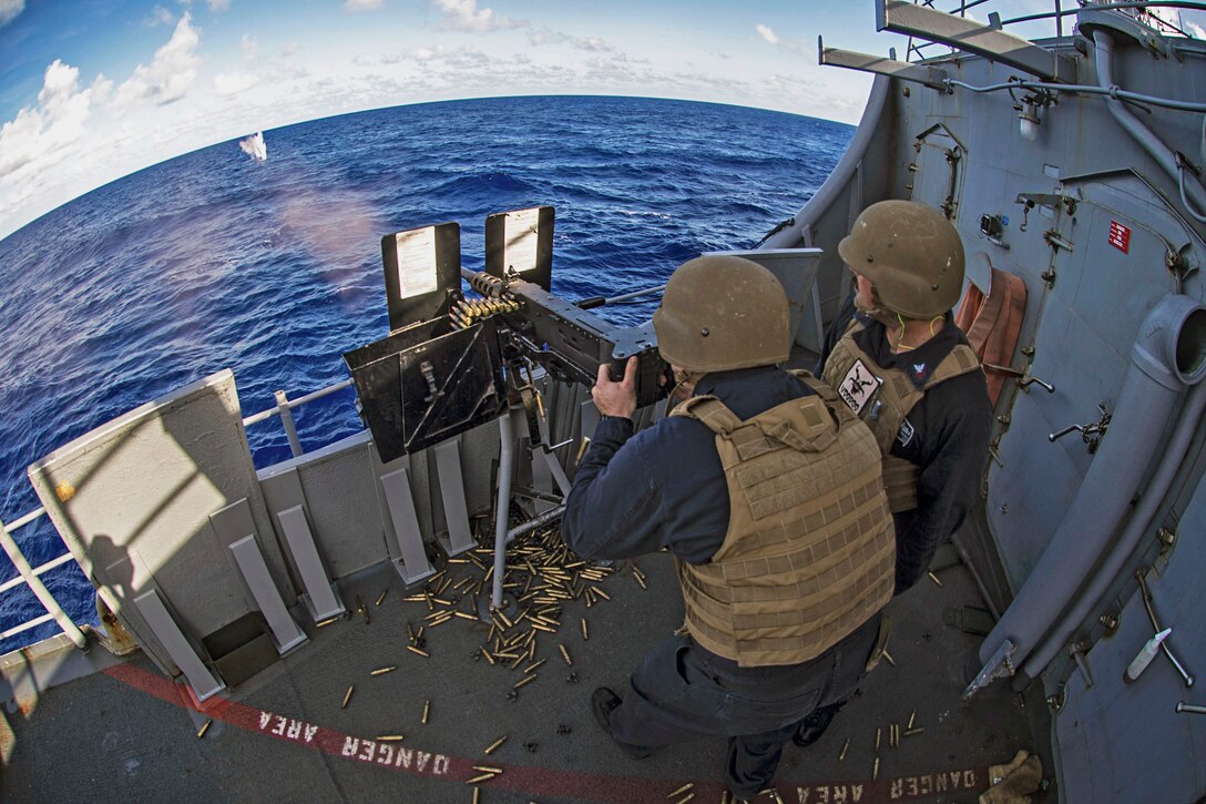 Navy Petty Officer 2nd Class Justin Parrish fires a .50-caliber machine gun during a weapons exercise aboard the Ticonderoga-class guided-missile cruiser USS Chancellorsville in the Philippine Sea, June 24, 2016. Navy photo by Petty Officer 2nd Class Andrew Schneider