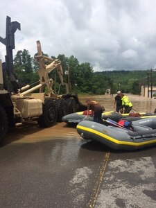 Members of the 811th Ordnance Company, 321st Ordnance Battalion, 38th Regional Support Group, perform rescue in partnership with local and state emergency first responders in the town of Rainelle, W.Va., following severe weather and flooding throughout the state 24 June, 2016.