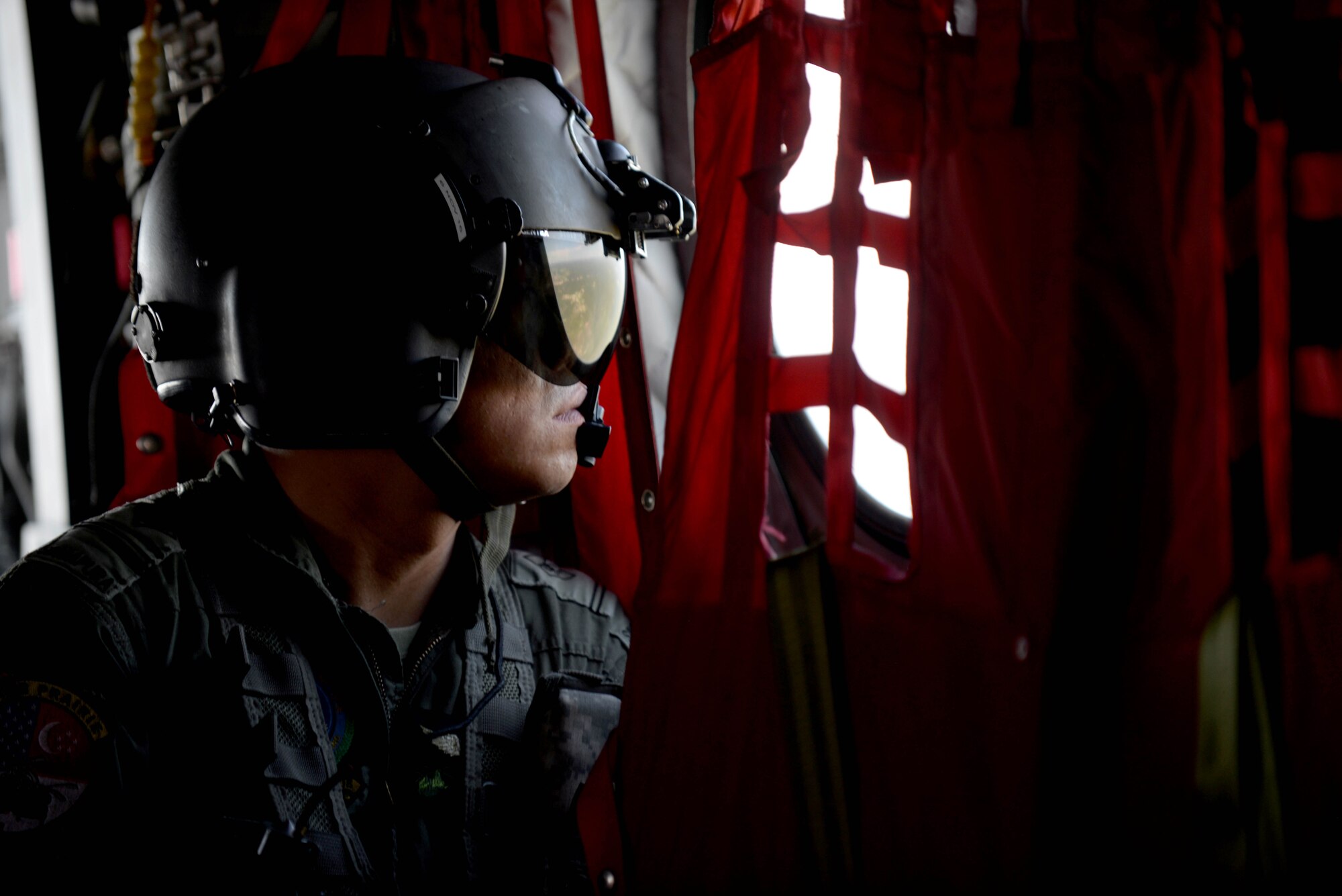 A Republic of Singapore Air Force aircrew member participates in Survival, Evasion, Resistance and Escape training aboard a CH-47D Chinook near Fort Meade, S.D., June 21, 2016. The helicopter transported 14 personnel to an area near Fort Meade to simulate the steps to be taken when stranded in hostile territory. (U.S. Air Force photo by Senior Airman Rebecca Imwalle/Released) 