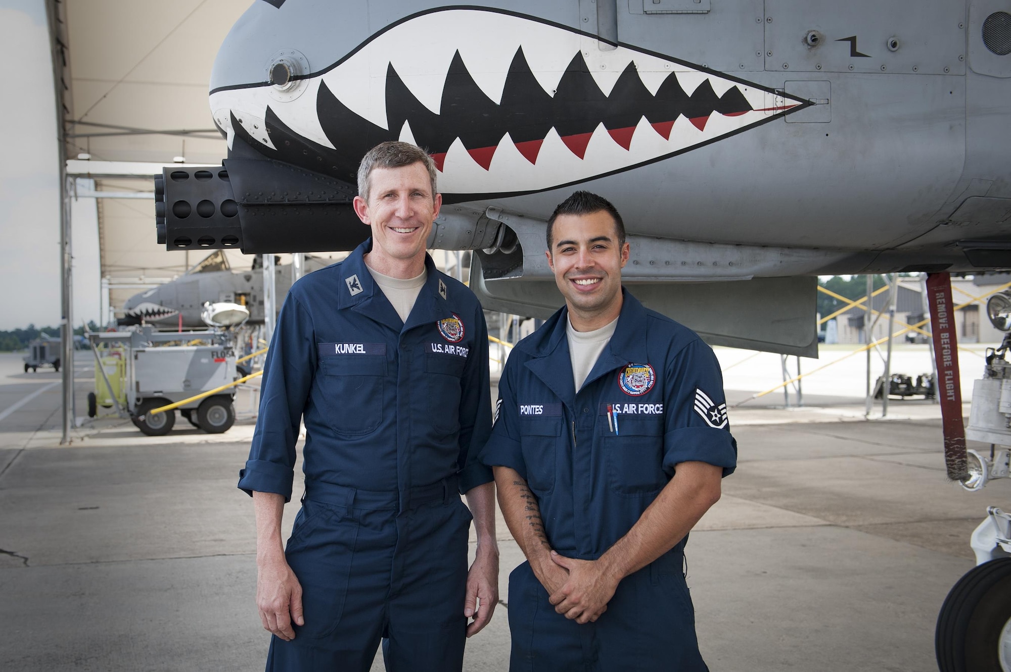 U.S. Air Force Col. Thomas Kunkel, 23d Wing commander, and Staff Sgt. Brian Pontes, 75th Aircraft Maintenance Unit crew chief, pose for a photo, June 27, 2016, at Moody Air Force Base, Ga. During his visit to the 23d Aircraft Maintenance Squadron, Kunkel wore coveralls to blend in and embrace the day-to-day life of a crew chief. (U.S. Air Force photo by Airman 1st Class Lauren M. Hunter/Released)