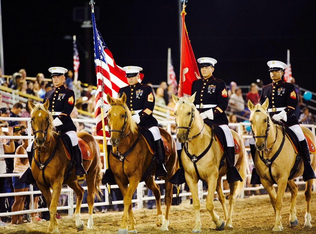 Sergeant Steward Tauch (far right) a member of the Marine Corps' last remaining Mounted Color Guard, along with Sgt. Terry Barker, Gunnery Sgt. Antonio Flores and Sgt. Yuki Buday, present colors at the Barstow Rodeo Stampede, Sept. 2015. 