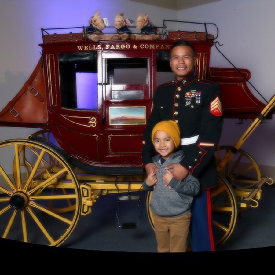 Sergeant Steward Tauch and his son Logan, age 7, share quality time at a pre-parade dinner during the Tournament of Roses festivities, in Pasadena, Calif., Dec. 31, 2015. 