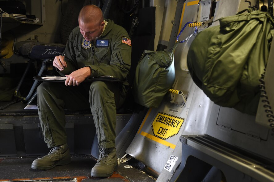 Staff Sgt. Matthew Phillips, 62nd Aircraft Maintenance Squadron flying crew chief, fills out paper work prior to a C-17 Globemaster III flight June 22, 2016, Libreville, Gabon Africa. Phillips has been an FCC for more than two and a half years. (U.S. Air Force photo/Tech. Sgt. Tim Chacon) 