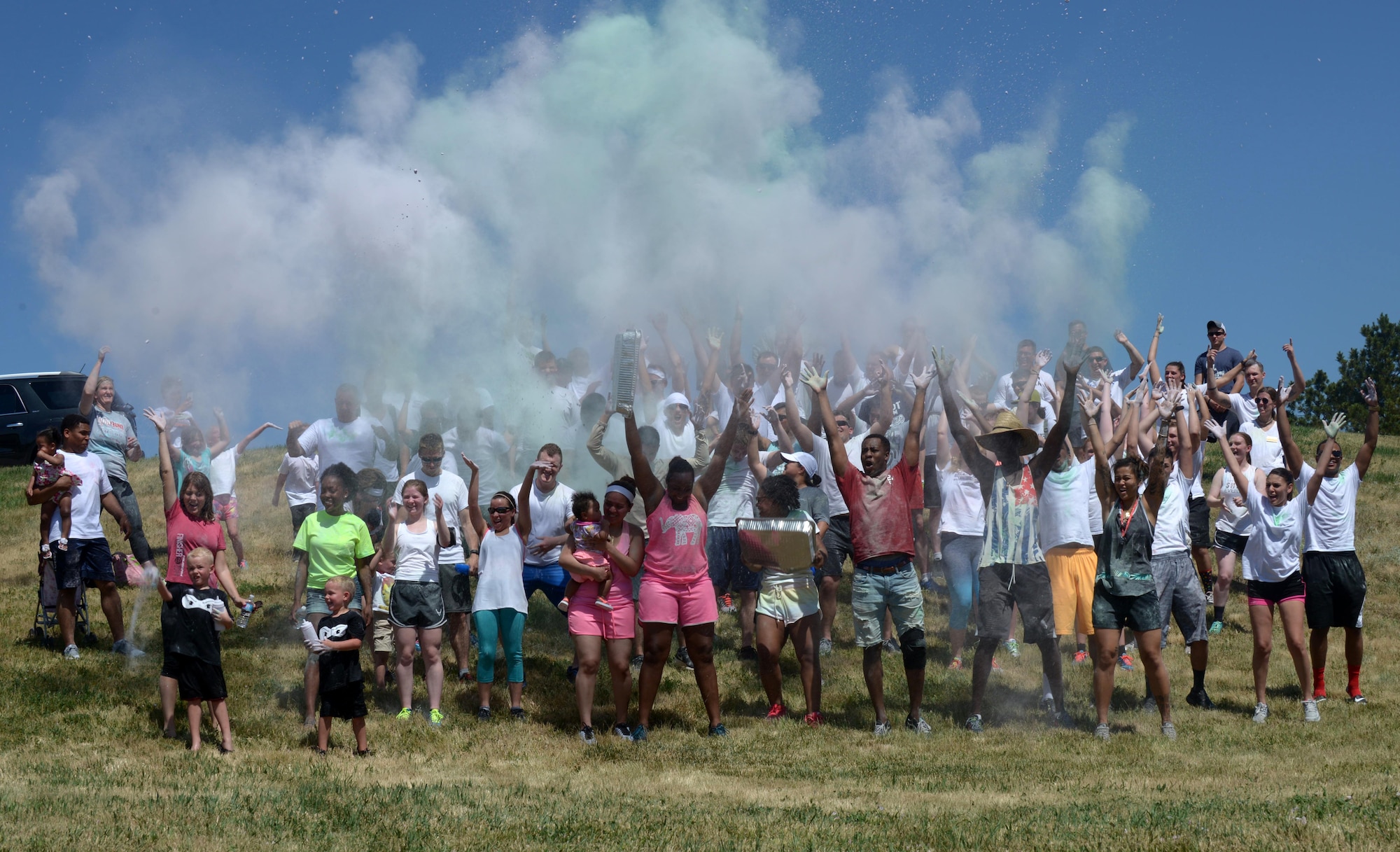 Participants of the Lesbian, Gay, Bisexual and Transgender Pride Month Color Run are plastered with pastel powder at Ellsworth Air Force Base, S.D., June 24, 2016. The Ellsworth Diversity Council hosted a color run to raise awareness for LGBT Pride Month and to bring the community together that more than 90 people attended. (U.S. Air Force photo by Airman Donald Knechtel/Released)