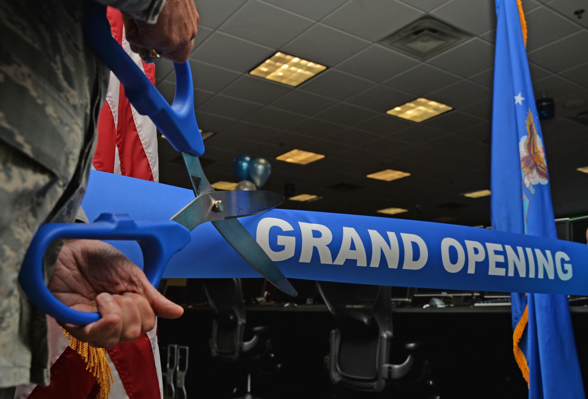 Col. David Austin, commander of the 505th Training Group, prepares to cut a ribbon to symbolize the re-opening of the Air Component Control Facility during a ceremony at Hurlburt Field, Fla., June 27, 2016. The 505th Combat Training Squadron building has been under renovations for seven months to update their facilities in order to increase mission readiness for the squadron’s live virtual and constructive training. (U.S. Air Force photo by Senior Airman Andrea Posey)
