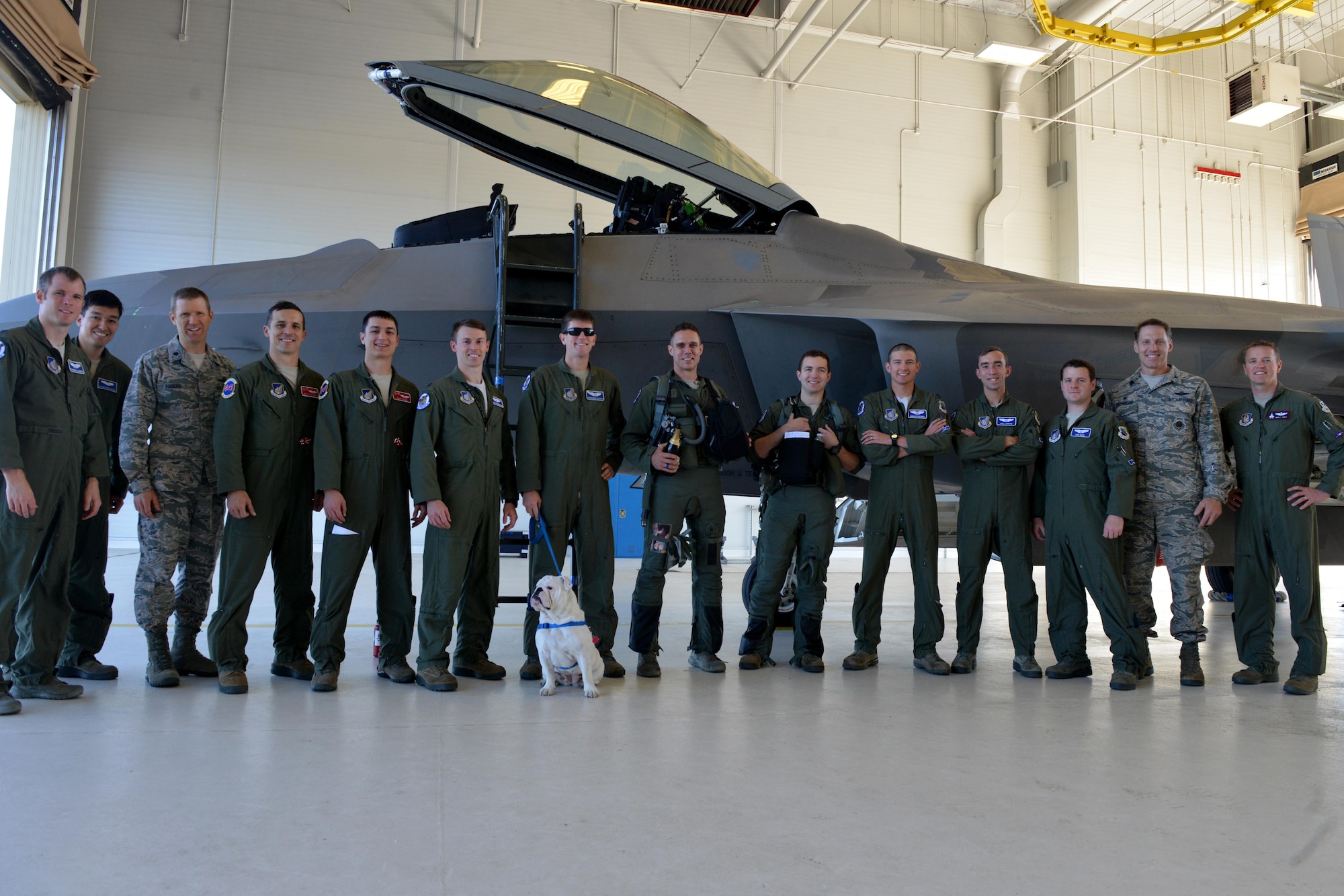 Joint Base Elmendorf-Richardson Airmen accompany Air Force Lt. Col. Brandon Tellez, 525th Fighter Squadron commander and F-22 Raptor pilot, following Tellez’s 1,000th flying hour in a Raptor at JBER, Alaska, June 22, 2016. Tellez reflected on his career in the Air Force; 14 years as a fighter pilot. (U.S. Air Force photo by Airman 1st Class Javier Alvarez)