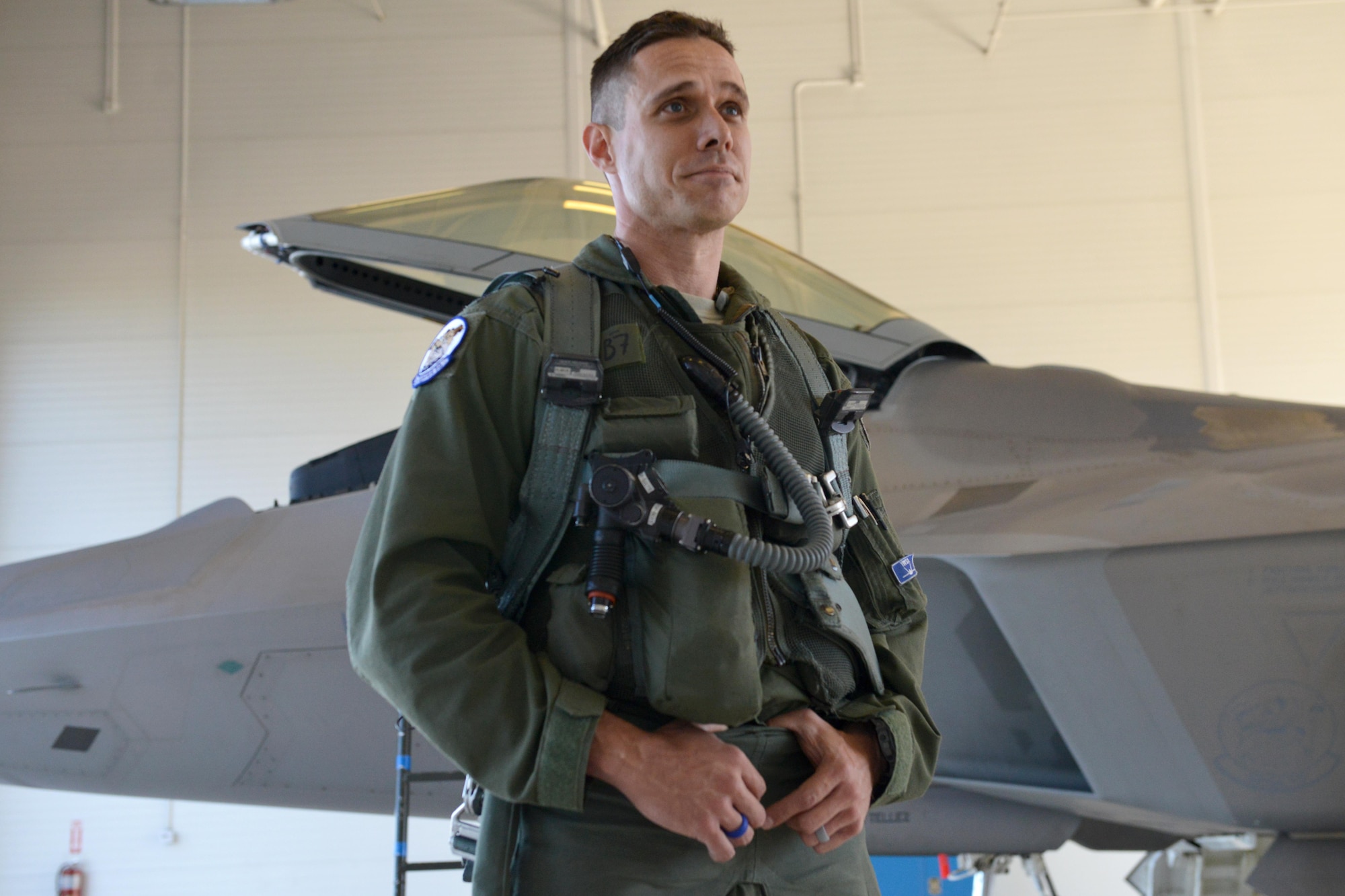 Air Force Lt. Col. Brandon Tellez, 525th Fighter Squadron commander and F-22 Raptor pilot, stands in front of his F-22 after having flown his 1,000th hour in the fighter, at Joint Base Elmendorf-Richardson, Alaska, June 22, 2016. Tellez was greeted by friends, coworkers, and the 525th FS mascot, following his flight. (U.S. Air Force photo by Airman 1st Class Javier Alvarez)