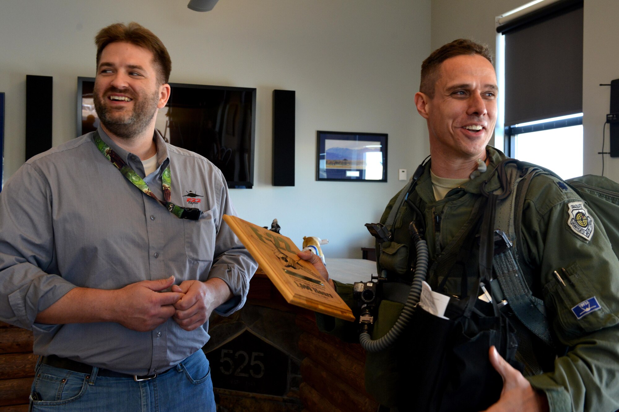 Air Force Lt. Col. Brandon Tellez, 525th Fighter Squadron commander and F-22 Raptor pilot, scoffs after discovering that he is the 23rd pilot to reach the milestone 1,000th hour in an F-22, at Joint Base Elmendorf-Richardson, Alaska, June 22, 2016. Tellez was presented with a plaque and patch only given to pilots who reach the 1,000-hour milestone. (U.S. Air Force photo by Airman 1st Class Javier Alvarez)