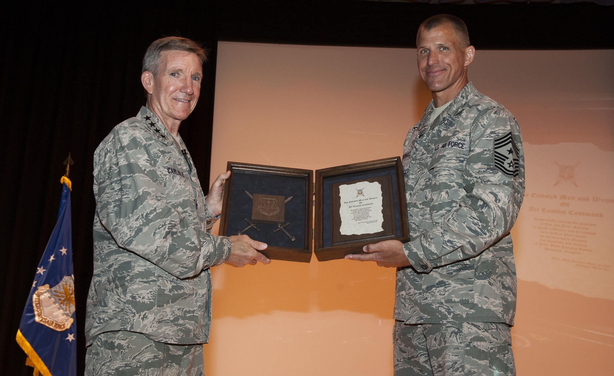 Gen. Hawk Carlisle, commander of Air Combat Command, is presented with an invitation to be inducted into the Order of the Sword by Chief Master Sgt. Steve K. McDonald, ACC command chief, during an enlisted all-call at Joint Base Langley Eustis, June 28, 2016. When accepting the invitation, an emotional Carlisle told the mostly enlisted audience “You have all made my life more than any man deserves.” The Order of the Sword is the highest honor Air Force enlisted Airmen can bestow upon a commissioned officer who has made significant contributions to the enlisted force. (U.S. Air Force photo by Staff Sgt. Nick Wilson/Released)