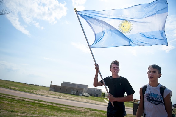 Jacob Searle, Ellicott high school student, carries the Argentinian flag to his next event during the Schriever School Age Care Olympic Day at Schriever Air Force Base, Colorado, Wednesday, June 22, 2016.  Ellicott summer program and SAC youth were divided into groups and assigned a country to “represent” during the event.  (U.S. Air Force Photo/Dennis Rogers)