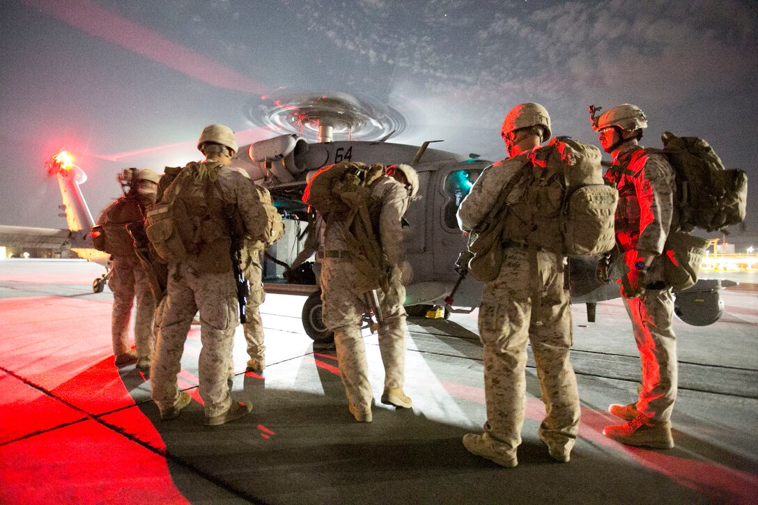 Marines prepare to board a UH-60 Seahawk to conduct fast-rope training during the 11th Marine Expeditionary Unit’s Realistic Urban Training aboard Marine Corps Air Station Yuma, Ariz., June 21, 2016. RUT helps prepare the 11th MEU Marines for their upcoming deployment, enhancing Marines' combat skills in a simulated urban environment similar to those they may find during combat missions. The Marines are with Charlie Co., Battalion Landing Team, 1st Bn., 4th Marines. The aircraft is with Helicopter Sea Combat Squadron Two One (HSC-21). (U.S. Marine Corps photo by Sgt. Xzavior T. McNeal/Released)