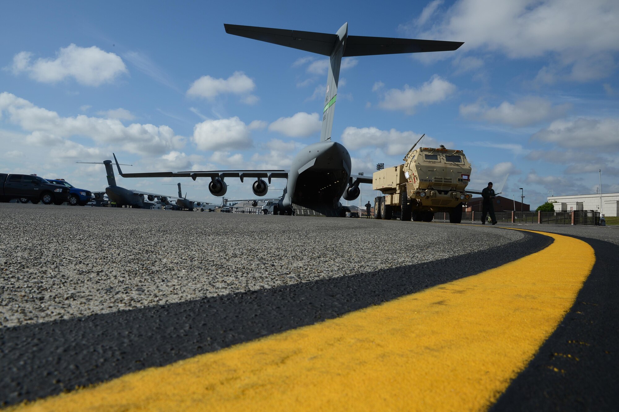 Senior Airman Patrick Bullard (right), 7th Airlift Squadron loadmaster, inspects a High Mobility Artillery Rocket System to load onto a C-17 Globemaster III June 22, 2016 at Joint Base Lewis-McChord, Wash. Soldiers from the 17th Field Artillery Brigade worked with Airmen during a rapid infiltration HI-RAIN exercise to transport two HIMARS vehicles to Moses Lake, Wash., and back. (U.S. Air Force photo/Senior Airman Jacob Jimenez) 