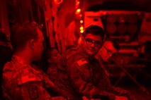 Soldiers from the 17th Field Artillery Brigade and crewmembers for the High Mobility Artillery Rocket System discuss mission operations June 22, 2016 while in flight to Moses Lake, Wash., from Joint Base Lewis-McChord, Wash., during a rapid infiltration HI-RAIN exercise. Their participation in the exercise called “Thunder Rain” was to help them become proficient in rapidly deploying and infiltrating enemy territory using HIMARS. (U.S. Air Force photo/ Senior Airman Jacob Jimenez) 