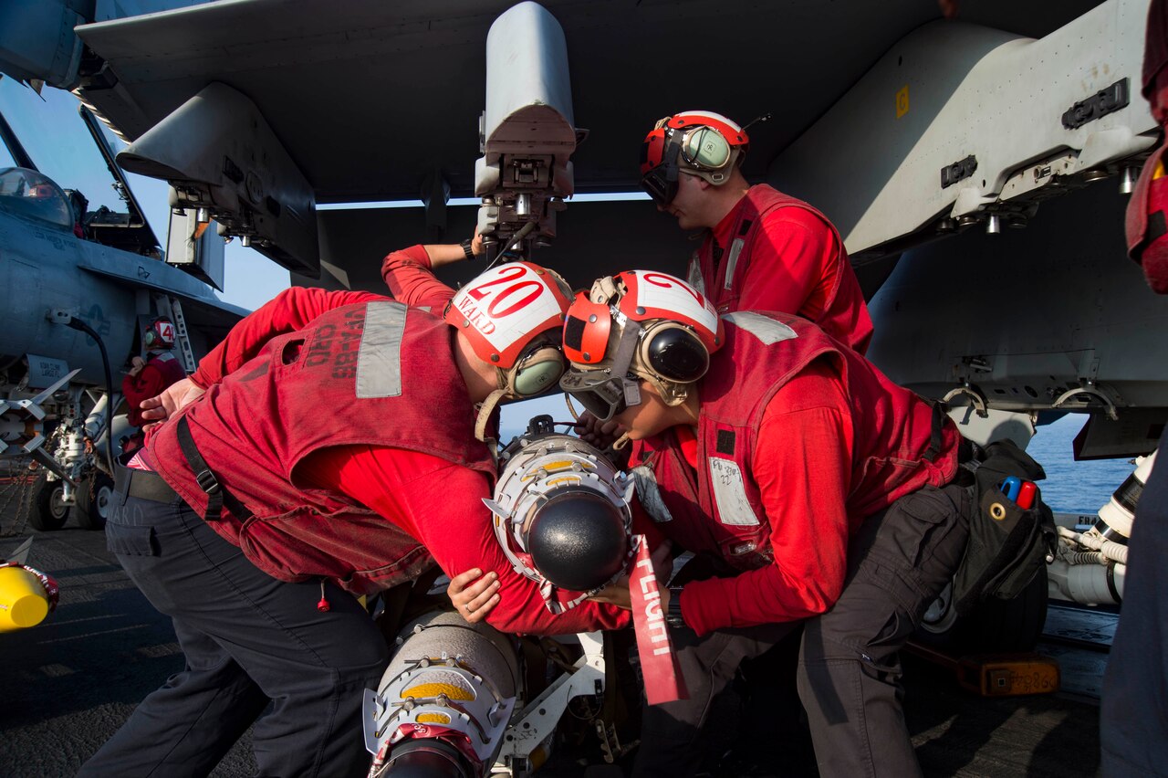 Navy sailors prepare to load ordnance on an F/A-18E Super Hornet assigned to the Sidewinders of Strike Fighter Squadron 86 on the flight deck of the aircraft carrier USS Dwight D. Eisenhower in the Mediterranean Sea, June 28,2016. The Dwight D. Eisenhower is deployed in support of Operation Inherent Resolve, maritime security operations and theater security operation efforts in the U.S. 6th Fleet area of operations. U.S. Navy photo by Petty Officer 3rd Class Anderson W. Branch
 