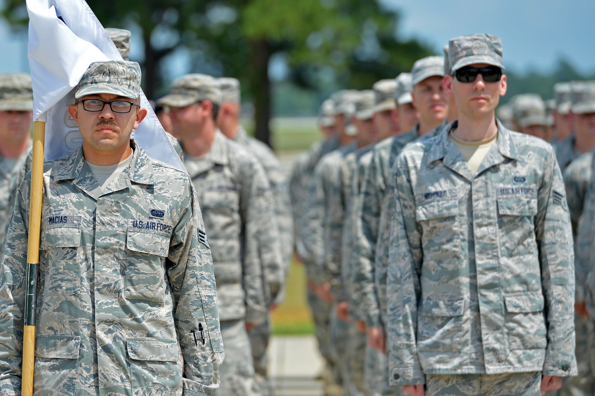 U.S. Airmen assigned to the Senior Master Sgt. David B. Reid Airman Leadership School Class 16-05 stand at attention during a final retreat ceremony at Shaw Air Force Base, S.C., June 27, 2016. ALS Airmen were observed by instructors and base leadership for precision and accuracy throughout the ceremony. (U.S. Air Force photo by Airman 1st Class Christopher Maldonado)