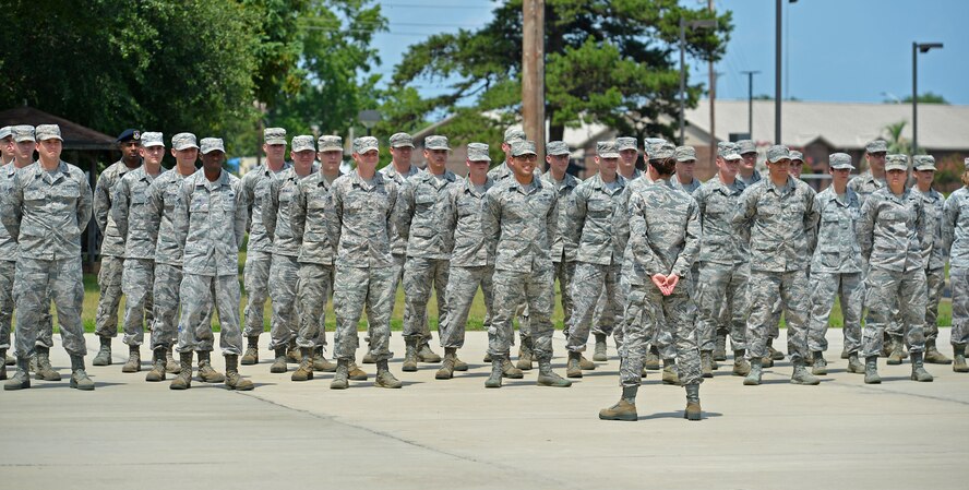 U.S. Airmen assigned to the Senior Master Sgt. David B. Reid Airman Leadership School Class 16-05 stand at parade rest before a retreat ceremony at Shaw Air Force Base, S.C., June 27, 2016. During the retreat, the American flag was lowered to signify the end of the duty day. (U.S. Air Force photo by Airman 1st Class Christopher Maldonado)