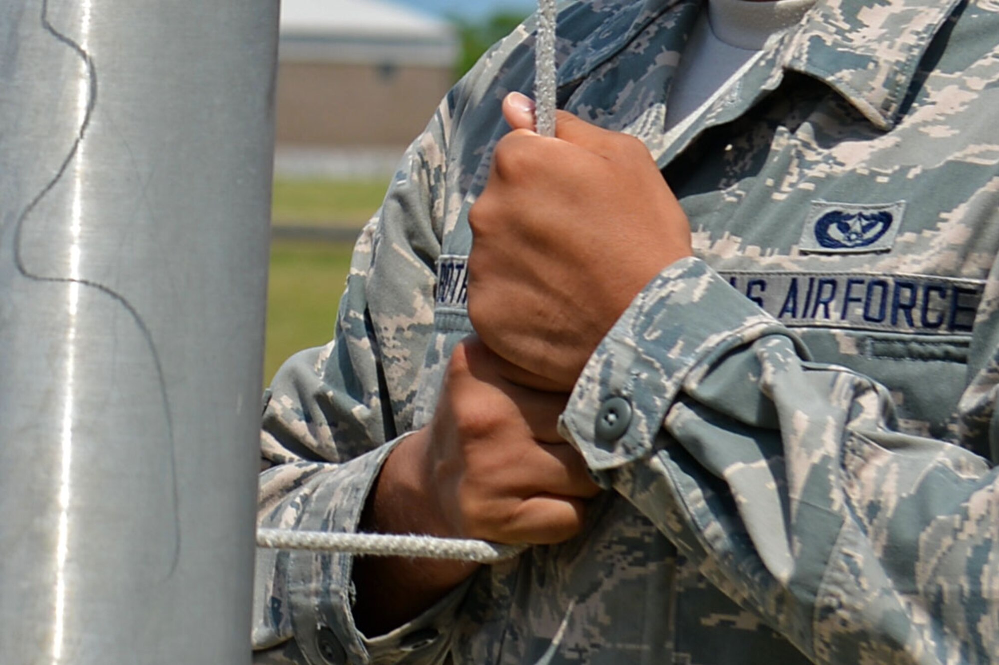 A U.S. Airman assigned to the Senior Master Sgt. David B. Reid Airman Leadership School Class 16-05 holds a halyard during a retreat ceremony at Shaw Air Force Base, S.C., June 27, 2016. The halyard was used to lower and raise the American flag during reveille and retreat. (U.S. Air Force photo by Airman 1st Class Christopher Maldonado) 