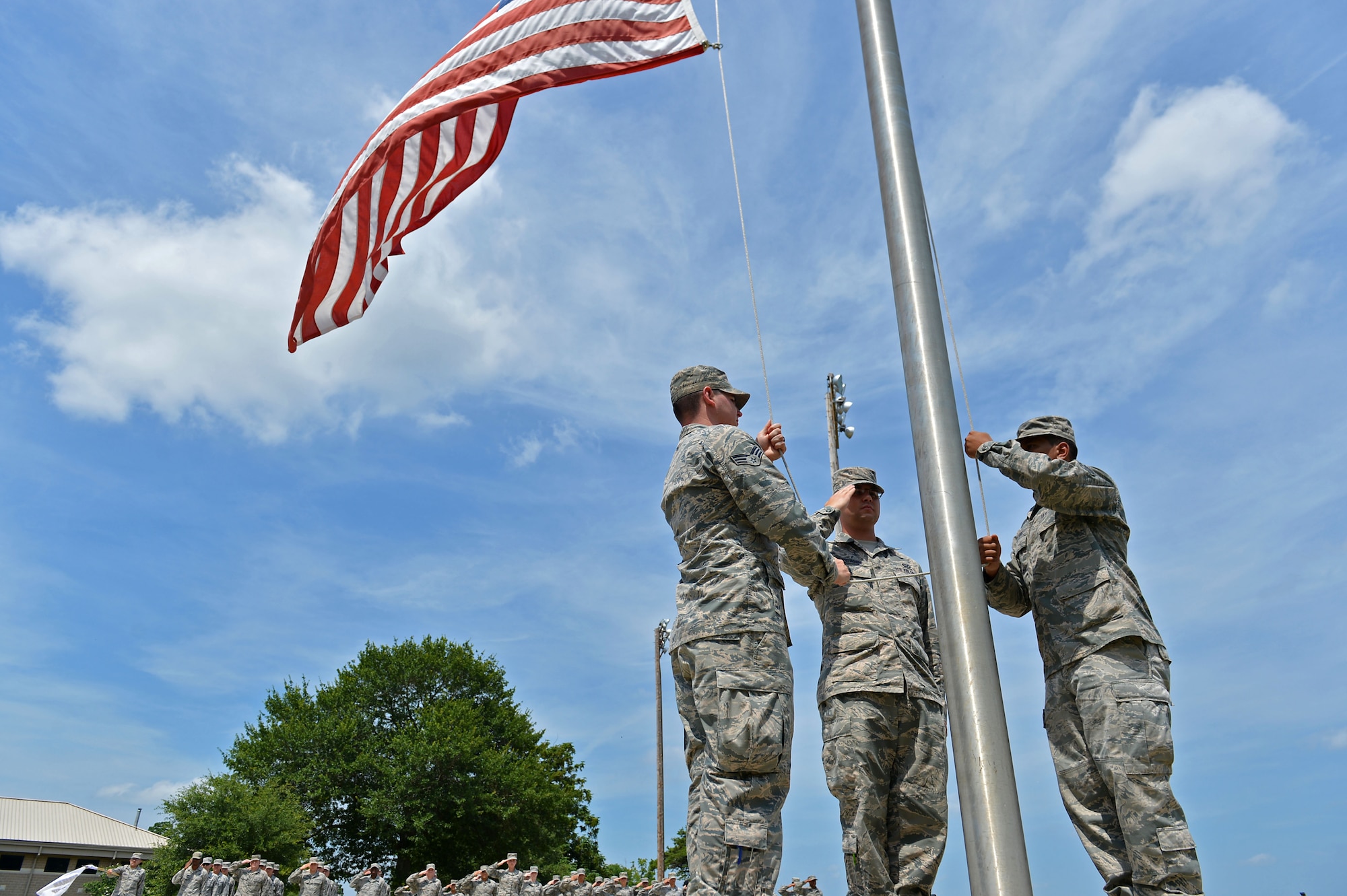 U.S. Airmen assigned to the Senior Master Sgt. David B. Reid Airman Leadership School Class 16-05 salute the American flag as it is lowered during a retreat ceremony at Shaw Air Force Base, S.C., June 27, 2016. The retreat ceremony signaled the end of the duty day and paid respect to the flag. (U.S. Air Force photo by Airman 1st Class Christopher Maldonado) 