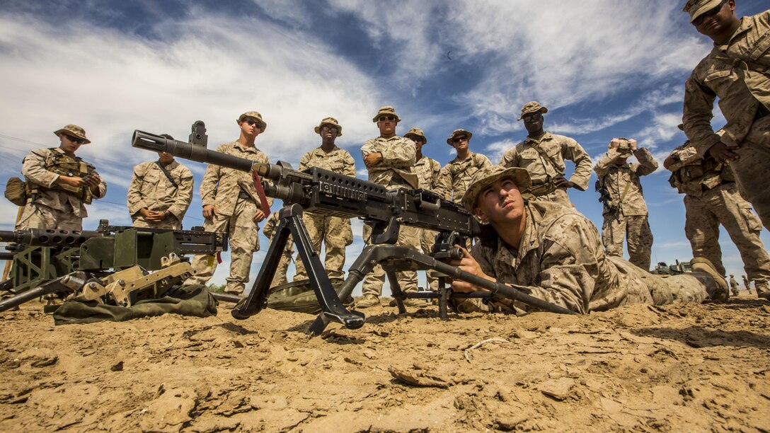 Lance Cpl. Matthew Jones listens to a Marine while manning a M240B medium machine gun during the 11th Marine Expeditionary Unit’s Combined Arms Exercise 2016 at Marine Corps Air Ground Combat Center Twenty-nine Palms, Calif., June 9, 2016. Jones is an armorer with CLB- 11, 11th MEU. (U.S. Marine Corps photo by Cpl. April L. Price/ Released)