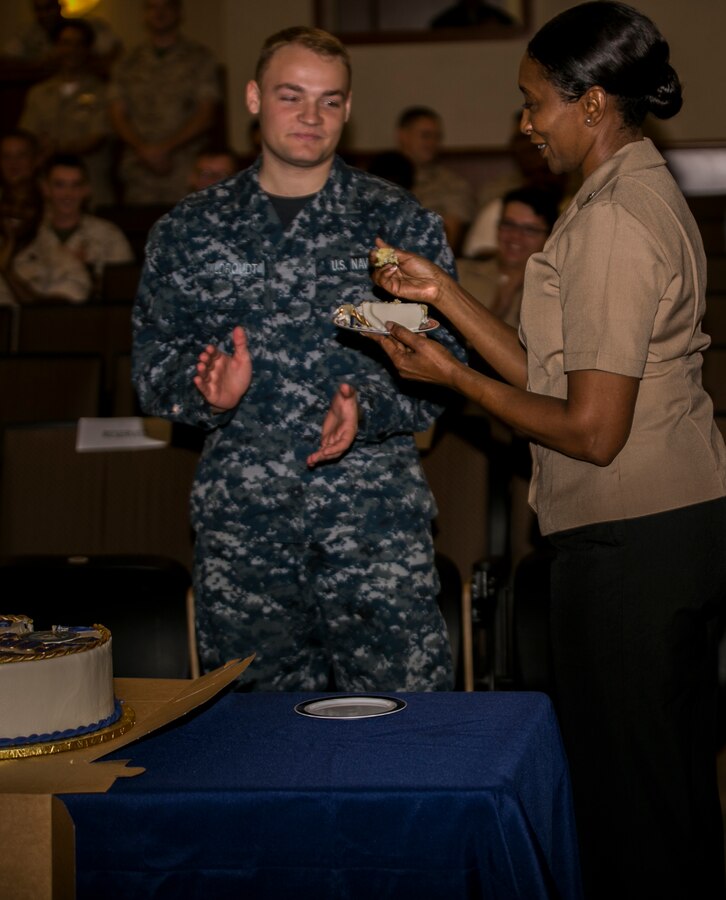 Hospital Corpsman Petty Officer 1st Class Debra Pee (right), and Hospital Corpsman Michael Wildroudt (left), the most senior and junior hospital corpsman in their unit, take their first bite of cake during the 118th Hospital Corpsman birthday celebration at Marine Corps Support Facility New Orleans, June 28, 2016. The cake cutting ceremony signifies the importance of the rich history of the Navy Hospital Corps and the legacy its members are expected to continue. 
