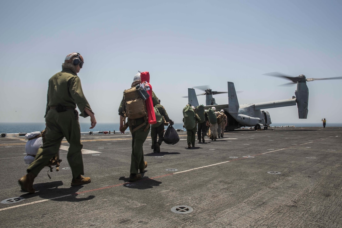 ARABIAN GULF (June 13, 2016) Marines and Sailors with the 13th Marine Expeditionary Unit and Boxer Amphibious Ready Group file into a MV-22B Osprey helicopter aboard USS Boxer (LHD 4) for sustainment training ashore in the U.S. 5th Fleet and Central Command areas of responsibility June 13. The 13th MEU is conducting sustainment training to maintain proficiency and combat readiness while deployed with the Boxer Amphibious Ready Group during Western Pacific Deployment 16-1. (U.S. Marine Corps photo by Cpl. Alvin Pujols/ RELEASED)