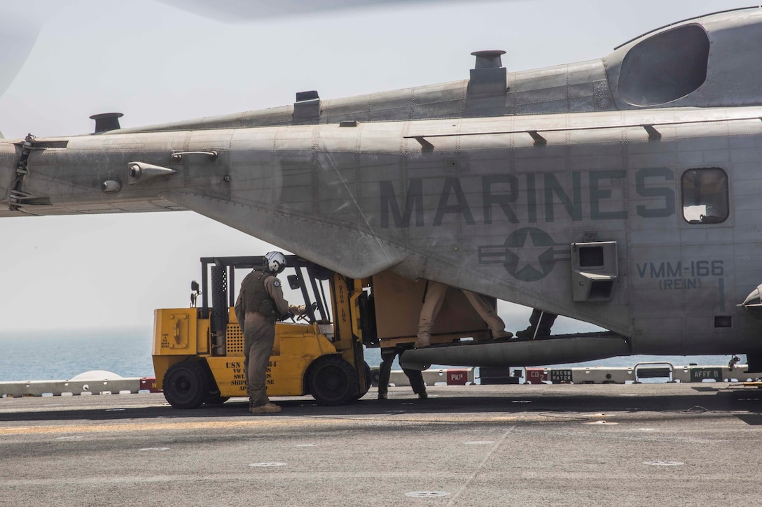 ARABIAN GULF (June 13, 2016) Marines and Sailors from the 13th Marine Expeditionary Unit load pallets into a CH-53E Super Stallion helicopter  aboard USS Boxer (LHD 4), in preparation for sustainment training in the U.S. 5th Fleet and Central Command areas of responsibility June 13. The 13th MEU is conducting sustainment training to maintain proficiency and combat readiness while deployed with the Boxer Amphibious Ready Group during Western Pacific Deployment 16-1. (U.S. Marine Corps photo by Cpl. Alvin Pujols/ RELEASED)
