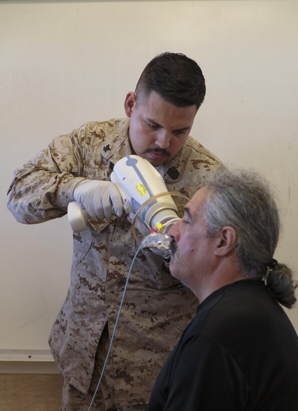 Petty Officer 3rd Class Zarur Deleontorres, a hospital corpsman with 4th Dental Battalion, 4th Marine Logistics Group, Marine Forces Reserve, x-rays a patient at Kapaa Middle School during Innovative Readiness Training Tropic Care 2016, June 25, 2016. IRT Tropic Care 2016 is part of a civil and joint military program to improve military readiness while simultaneously providing quality services to underserved communities throughout the United States. (U.S. Marine Corps photo by Sgt. Ian Leones/Released)