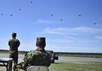 In this photo, Japanese Maj. Gen. Yasuyuki Kodama, commanding general of the Japan Ground Self Defense Force's 1st Airborne Brigade, observes his paratroopers as they perform an airborne proficiency operation over Malemute Drop Zone during Exercise Arctic Aurora at Joint Base Elmendorf-Richardson, Alaska June 9, 2016. Arctic Aurora is a yearly bilateral training exercise involving elements of the Spartan Brigade and the JGSDF, which focuses on strengthening ties between the two by executing combined small unit airborne proficiency operations and basic small arms marksmanship. 